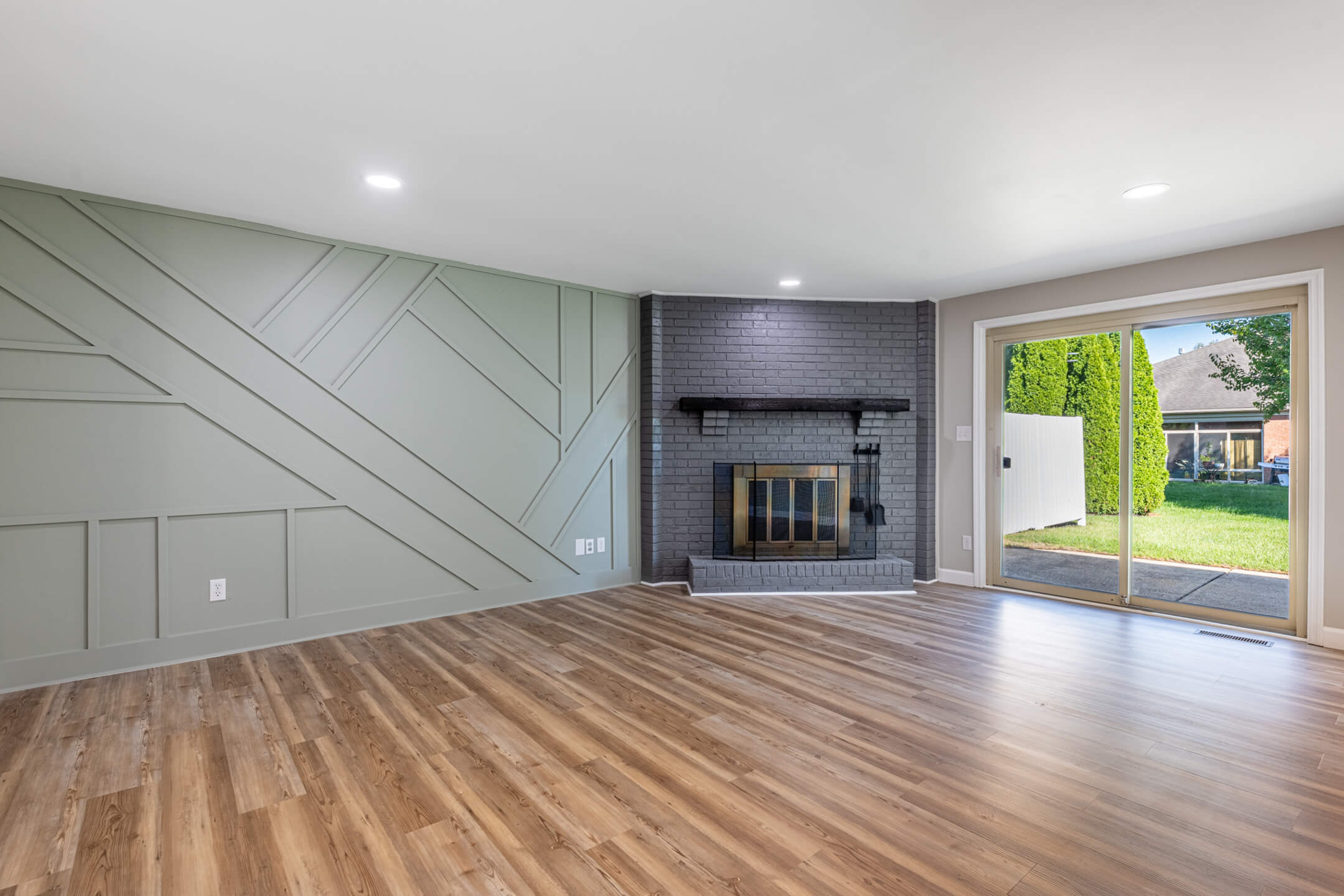 Living room with stone fireplace and beams